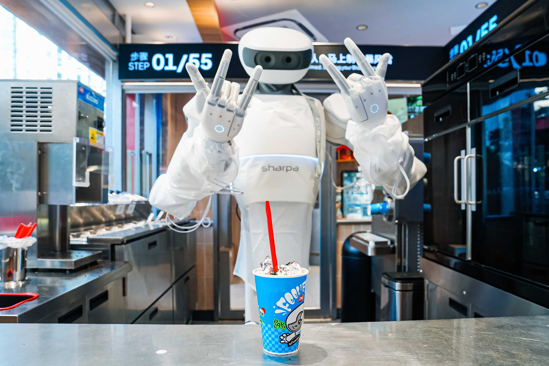 A white Sharpa humanoid robot behind a Dairy Queen counter holding out a finished Blizzard cup with a red straw, a “STEP 01/55” sign on the wall behind it.